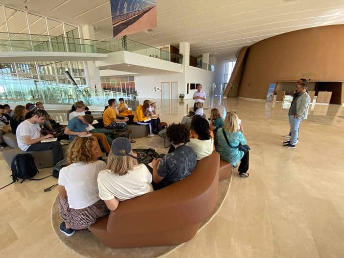 Students from the International School of Geneva - Campus des Nations listening to an introductory lecture at the visitors centre